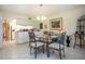 Bright dining room featuring tile floors, a glass table set, and white walls at 3615 Puerta Ct # 8516, Sarasota, FL 34232