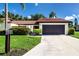 Charming single-story home featuring a well-manicured lawn, tile roof, and attached two-car garage at 3615 Puerta Ct # 8516, Sarasota, FL 34232