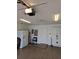 Functional garage interior with white door, cabinets, and refrigerator providing extra storage at 3615 Puerta Ct # 8516, Sarasota, FL 34232