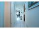 Hallway featuring tile flooring, neutral decor, and closet space at 3615 Puerta Ct # 8516, Sarasota, FL 34232