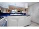 Bright kitchen featuring white cabinets with dark countertops and stainless steel appliances at 3615 Puerta Ct # 8516, Sarasota, FL 34232