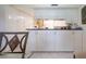 Kitchen with lots of bright white cabinets with dark countertops and modern hardware at 3615 Puerta Ct # 8516, Sarasota, FL 34232