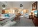 Spacious living room with vaulted ceilings, neutral carpeting, and seamless flow into the dining area at 3615 Puerta Ct # 8516, Sarasota, FL 34232