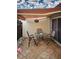 Covered patio features tiled flooring, comfortable seating, and privacy from neighbors at 3615 Puerta Ct # 8516, Sarasota, FL 34232