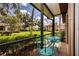 Relaxing patio with ornate bistro set overlooking manicured lawn and lush landscaping at 3615 Puerta Ct # 8516, Sarasota, FL 34232