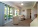 Sunroom featuring wicker chairs, ceiling fan, and sliding glass doors leading to the outdoors at 3615 Puerta Ct # 8516, Sarasota, FL 34232
