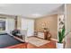 Spacious bonus room featuring a pool table, adjacent wet bar, neutral color palette, and wood-look floors at 3636 Torrey Pines Blvd, Sarasota, FL 34238
