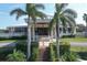 Exterior of the community clubhouse featuring a grand entrance and manicured landscaping at 3636 Torrey Pines Blvd, Sarasota, FL 34238
