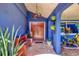 Inviting front porch with tiled flooring, bench seating, potted plants, and a unique ceiling light fixture at 3636 Torrey Pines Blvd, Sarasota, FL 34238