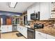 Beautiful kitchen featuring tile backsplash, stainless steel appliances, and ample counter space with modern finishes at 3636 Torrey Pines Blvd, Sarasota, FL 34238
