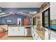 Open-concept kitchen with granite countertops, stainless steel appliances, and a view to the beautiful backyard pool at 3636 Torrey Pines Blvd, Sarasota, FL 34238