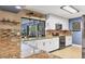 Bright kitchen featuring granite countertops, white cabinetry, modern appliances, and a window looking to the outside at 3636 Torrey Pines Blvd, Sarasota, FL 34238