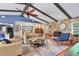 Large living room featuring a stone fireplace, hardwood floors, and an open layout that connects to the kitchen and dining areas at 3636 Torrey Pines Blvd, Sarasota, FL 34238