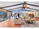 Bright living room featuring wood floors, vaulted ceiling with wood beams, and open access to other living areas at 3636 Torrey Pines Blvd, Sarasota, FL 34238