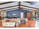 Spacious living room featuring high ceilings, exposed wood beams, and stylish decor that create a comfortable and inviting space at 3636 Torrey Pines Blvd, Sarasota, FL 34238