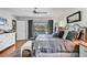 Bright main bedroom with a king bed, hardwood floors, and sliding glass doors to the pool area at 3636 Torrey Pines Blvd, Sarasota, FL 34238