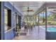 Relaxing outdoor patio with tile flooring, ceiling fans, a bar window, and pool views at 3636 Torrey Pines Blvd, Sarasota, FL 34238