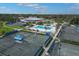 Aerial view of tennis courts and pool area, offering a recreational lifestyle with lush landscaping at 3636 Torrey Pines Blvd, Sarasota, FL 34238