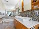 Bathroom featuring double sinks and natural lighting at 3900 Country View Dr, Sarasota, FL 34233
