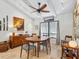 Modern dining room area features a table with seating for four, a large window, and art at 3900 Country View Dr, Sarasota, FL 34233