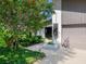 A charming home featuring a modern address number display and a side-entry garage, complemented by lush landscaping at 3900 Country View Dr, Sarasota, FL 34233