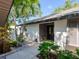 Inviting front entrance featuring a double door entry, complemented by tropical landscaping and a walkway at 3900 Country View Dr, Sarasota, FL 34233