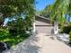 Home with an attached two-car garage, driveway, and manicured landscaping for a welcoming curb appeal at 3900 Country View Dr, Sarasota, FL 34233