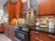 The kitchen boasts wooden cabinets, stainless steel appliances, and decorative tile backsplash at 3900 Country View Dr, Sarasota, FL 34233