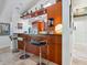 Kitchen bar area with wood cabinets, stone countertops, and seating for casual dining at 3900 Country View Dr, Sarasota, FL 34233