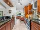 Open kitchen features wooden cabinets, stainless steel appliances, and access to the living room at 3900 Country View Dr, Sarasota, FL 34233