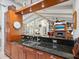 The kitchen bar offers seating and views of the living room with fireplace and vaulted ceilings at 3900 Country View Dr, Sarasota, FL 34233