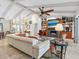 Cozy living room featuring fireplace, built-in shelving, tile floors, and vaulted ceilings at 3900 Country View Dr, Sarasota, FL 34233