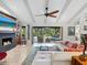 Bright living room boasts a fireplace, high ceilings, and access to the screened outdoor space at 3900 Country View Dr, Sarasota, FL 34233