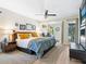 Comfortable primary bedroom retreat featuring stylish decor, wood floors, and a sitting area with backyard views at 3900 Country View Dr, Sarasota, FL 34233