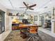 Bright office area showcasing built-in shelving, a ceiling fan, track lighting, and a large wooden desk at 3900 Country View Dr, Sarasota, FL 34233