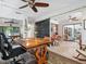 Wide angle view of an office with a rustic desk, an area rug, and a sliding barn door at 3900 Country View Dr, Sarasota, FL 34233