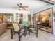 This patio features a seating area with a table and chairs, and sliding glass doors leading inside at 3900 Country View Dr, Sarasota, FL 34233