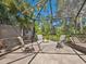 Screened patio area featuring comfortable seating around a modern fire pit, perfect for outdoor gatherings at 3900 Country View Dr, Sarasota, FL 34233