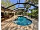 An outdoor swimming pool with a screened-in enclosure, sun deck, and covered patio at 3900 Country View Dr, Sarasota, FL 34233