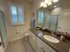Cozy bathroom featuring vanity, window with shutters, and shower with glass door at 4428 Conchfish Ln, Osprey, FL 34229