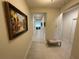 Hallway featuring tile flooring, neutral walls, and decorative artwork at 4428 Conchfish Ln, Osprey, FL 34229