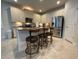 Bright kitchen with stainless steel appliances, granite countertops and counter seating at 4428 Conchfish Ln, Osprey, FL 34229