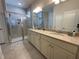 Spacious main bathroom with double vanity, granite countertops, and a tiled glass shower at 4428 Conchfish Ln, Osprey, FL 34229