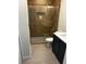 Modern bathroom featuring a stylish shower with glass doors, updated fixtures, and tiled floor at 522 31St W St, Bradenton, FL 34205