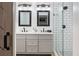 Bathroom features a gray double vanity, framed mirrors and tiled shower with glass door at 522 31St W St, Bradenton, FL 34205