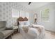 Bright bedroom with a queen bed, soft rug, and large window with blinds at 522 31St W St, Bradenton, FL 34205