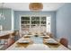 Bright dining room boasts a table set for dinner and a window to the beautiful backyard at 522 31St W St, Bradenton, FL 34205