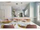 Beautiful dining room featuring a long table set for dinner and views of the modern kitchen at 522 31St W St, Bradenton, FL 34205