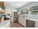 Modern kitchen with stainless steel appliances, white cabinets, and a window to the backyard at 522 31St W St, Bradenton, FL 34205