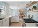 Bright kitchen with stainless appliances, gas cooktop, tile backsplash, and light wood floors at 522 31St W St, Bradenton, FL 34205